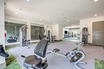 a home gym with exercise equipment and a bathtub at Century University City, Charlotte, NC